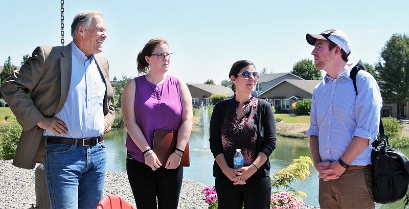 Craft3 Vice President Carl Seip, far right, explains his non-profit organization’s funding role to Gov. Jay Inslee, Jillian Nordstrom of the Dept. of Commerce and another state official.